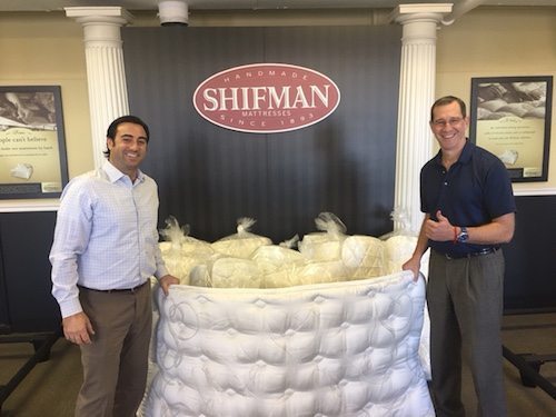 Bill Hammer, Shifman Mattress Co. president (left), and Phil Zucker, Shifman general manager, with the two-sided sleeping mats the company sent to Haiti