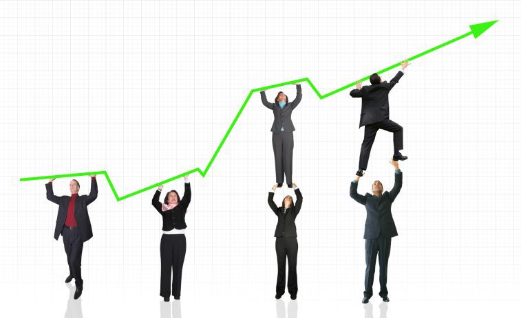business people pushing a graph upward