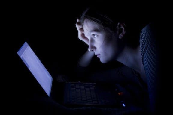 staring at computer screen in dark room