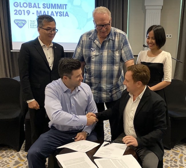 Spring Air’s Nick Bates (front left) and Eric Spitzer (back left) seal the deal with LMG/AmericanStar’s Lee Hinshaw (front right), Vu Tran and Tina Nguyen. 