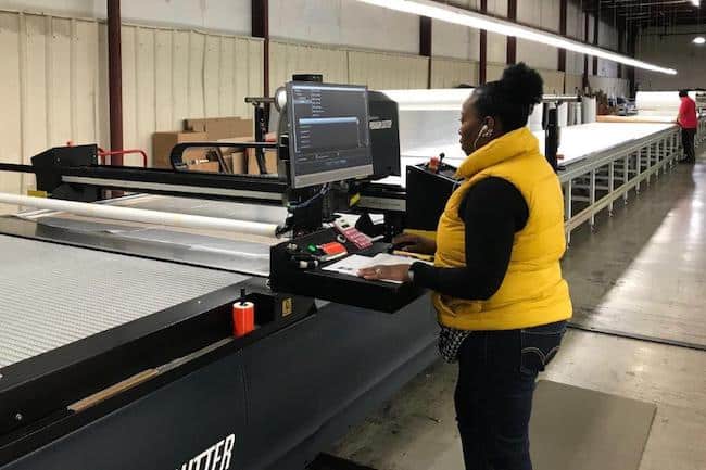 Colonial’s team uses the latest technology to cut materials with the highest degree of accuracy and consistency. Shown here is Tiffany Strickland. lead cutter.