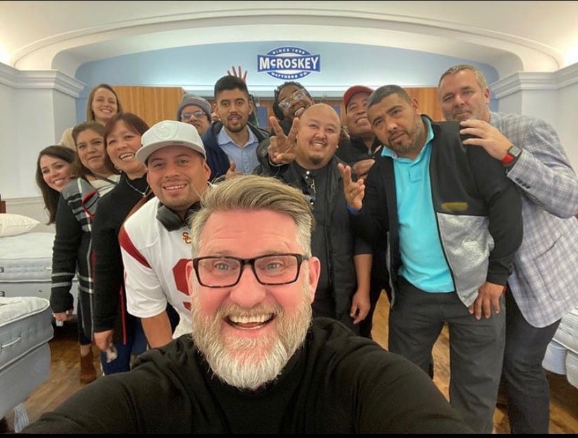 Pleasant Mattress Inc. President and Chief Executive Officer Rion Morgenstern snaps a selfie with a group of the company’s bed makers.