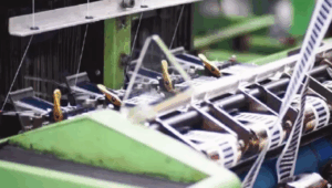 The company’s plant in Alamance can produce 6 million yards of tape and ribbon per week, or enough fabric to trim 350,000 mattresses.