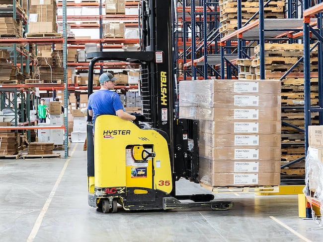 a forklift operator working at a Malouf warehouse
