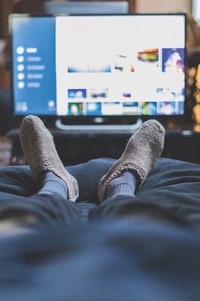 person falling asleep in front of tv feet in front of tv