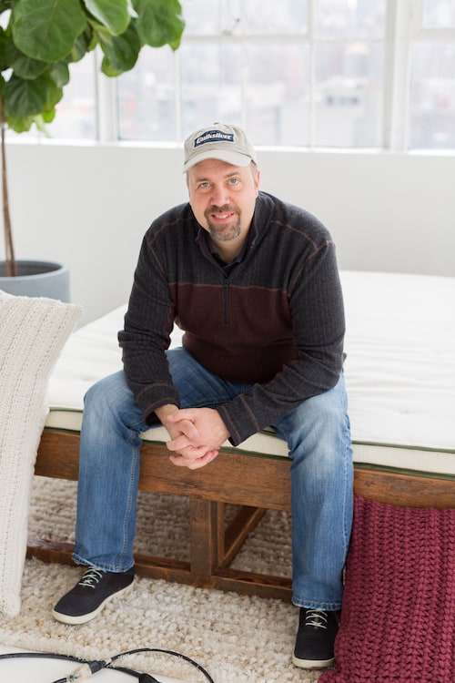 Mark Abrials sitting on Avocado mattress
