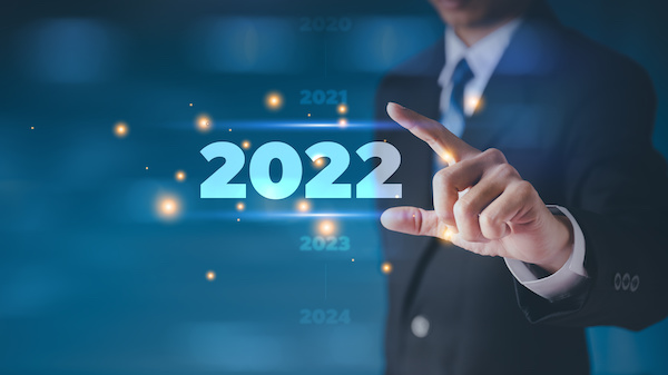 Businessman in a suit chooses his hand 2022 on a black background. new year start ideas It is a cutting-edge technology concept.