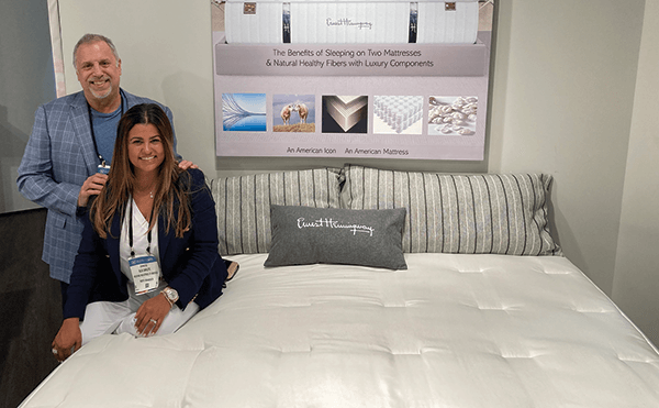 Bedding Industries of America CEO Stuart Carlitz and his wife and executive assistant, Elis Carlitz, pose by an Ernest Hemingway mattress.