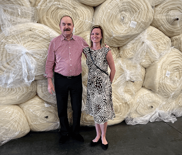 Peter Crone, left, owner and CEO of John Marshall & Co. Ltd., and Evi Brilleman, vice president of marketing and business development, stand by a wall of Joma Wool batting.