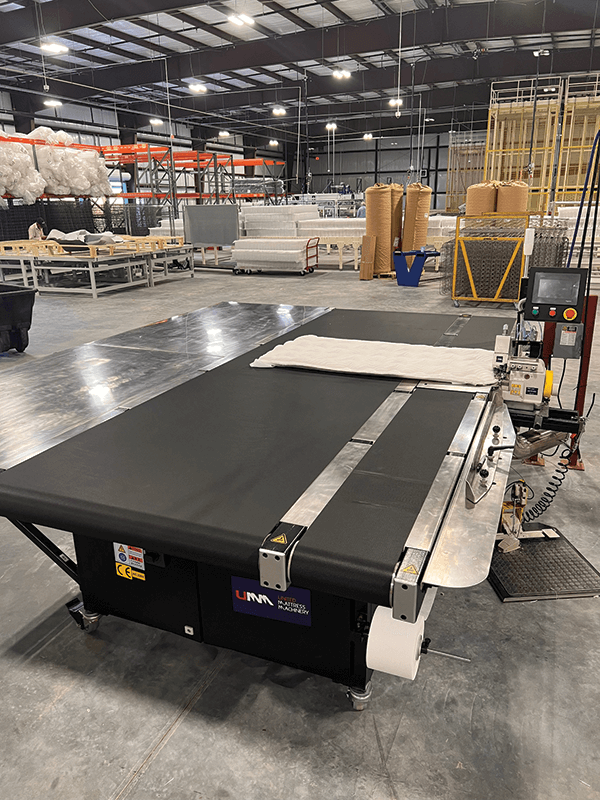 Sewing & Gluing Machinery Innovation. At United Mattress Machinery, customers are requesting the UM-5000 flange machine with the automatic belt table to help deskill the flange sewing operation and maintain consistency with panel quality.