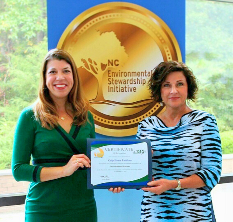 Elizabeth Biser, Secretary of the N.C. Dept. of Environmental Quality, presents the certificate recognizing Culp Home Fashions as an Environmental Partner in the Environmental Stewardship Initiative to Jenny Tinsley, manager of corporate communications & ESG for Culp, Inc.