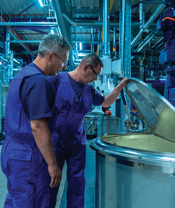 Sustainable Bio-Based Adhesives. SABA technicians inspect a production tank.