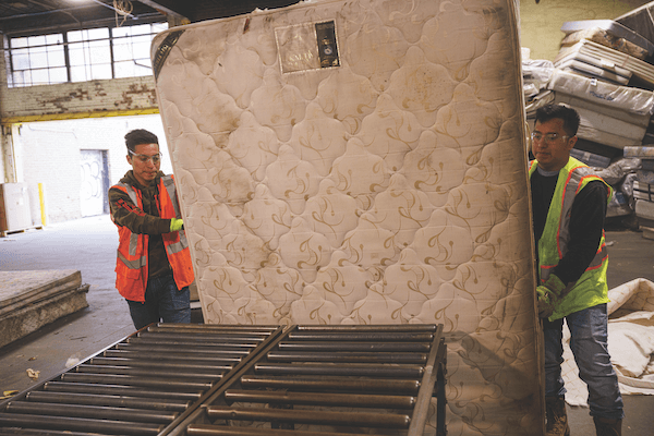 Casella workers dismantle some of the 50,000 mattresses that are discarded in the United States every day.