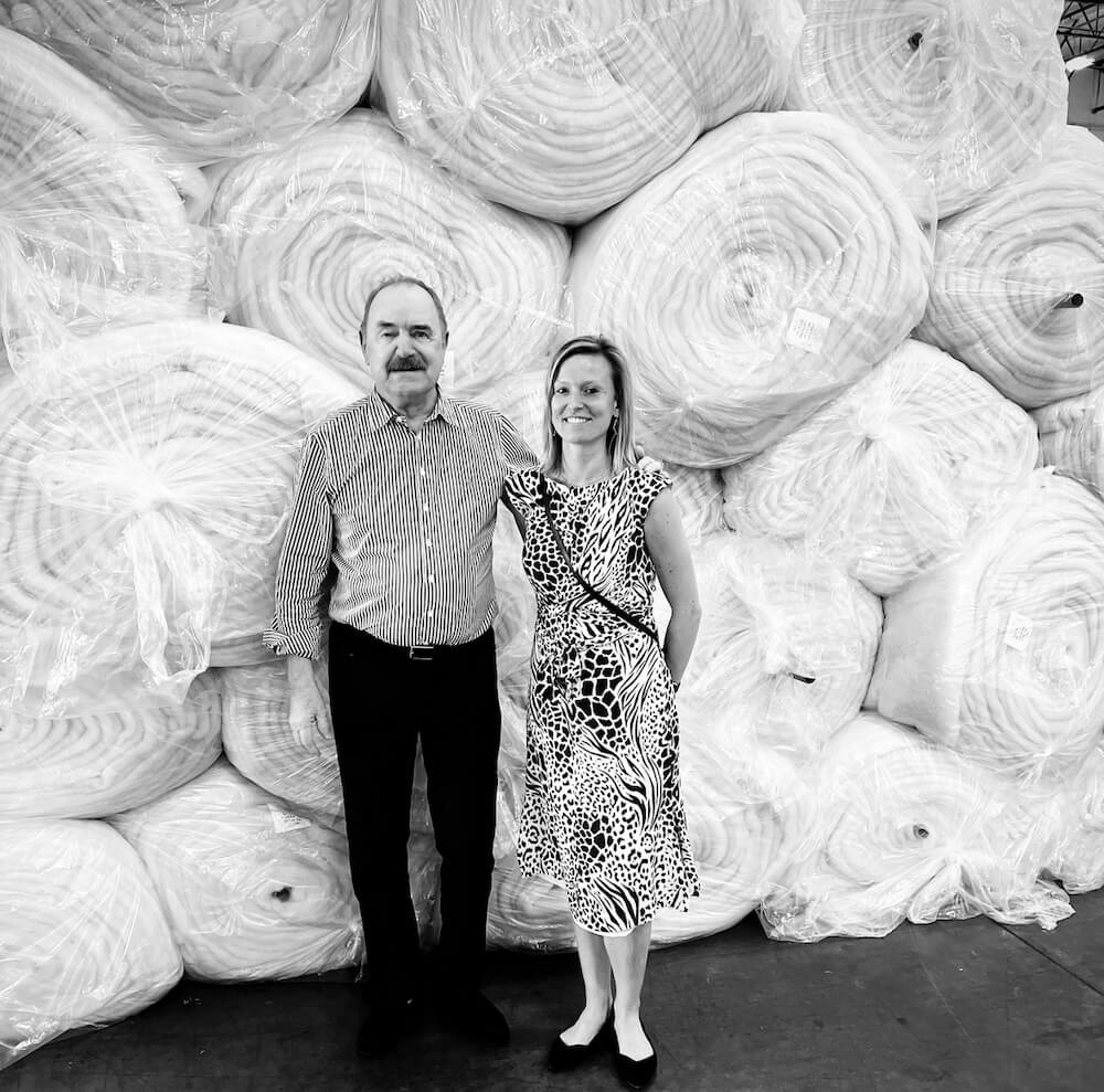 Peter Crone & Evi Brilleman in front of rolls of Joma Wool