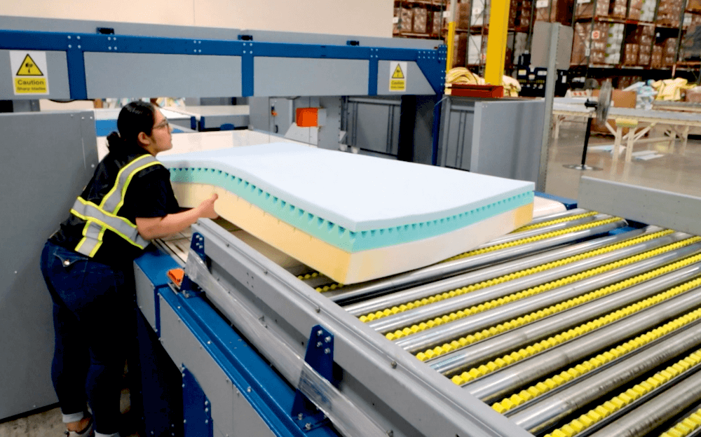 Foam cutoffs created from mattress manufacturing are collected at the end of the assembly line.