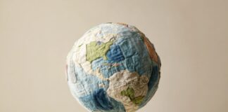 Sustainability, Sewing, and the Future of Bedding Minimalistic patchwork planet Earth made of recycled fabrics, symbolizing sustainability and upcycling concepts