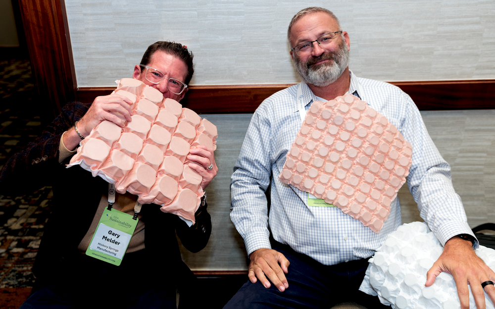 Mattress Circular Economy: ISPA Sustainability Conference. From left, Gary Melder and Jeff Jones of Hickory Springs Manufacturing have a little fun with the pocketed coils at their tabletop display.