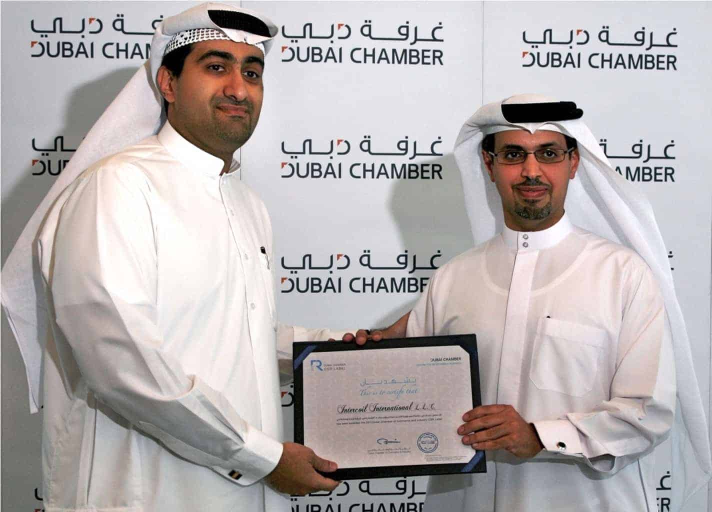 H.E. Hamad Buamim, director general of the Dubai Chamber of Commerce & Industry (right) presents Intercoil Managing Director Hassan Al Hazeem with the chamber’s corporate social responsibility award.