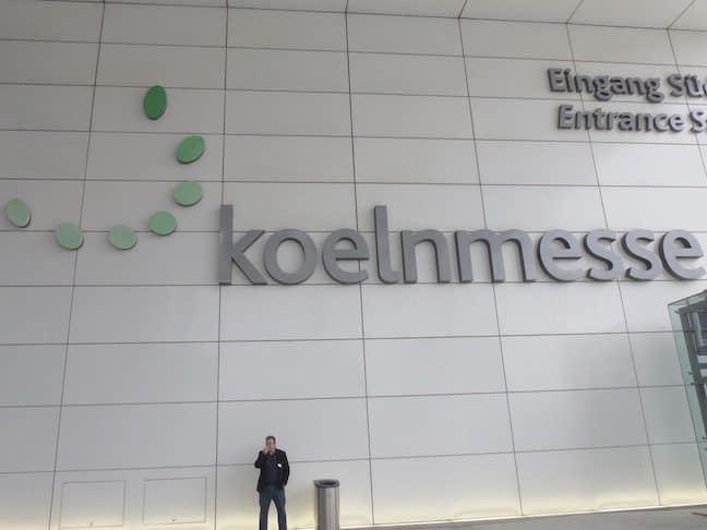 man standing in front of Koelnmesse marquee
