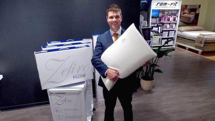 Don Wingate holds Protect-A-Bed Zefiro pillow 