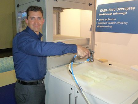 Jim Turner of Saba North America demonstrates adhesive spray gun