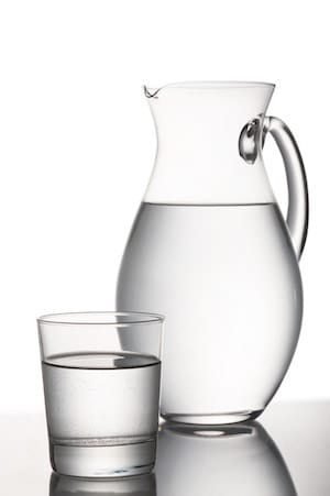 jug and glass full of water, on white background