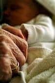 hands of elderly person and baby