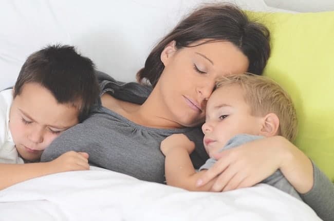 sleeping mom with her two children