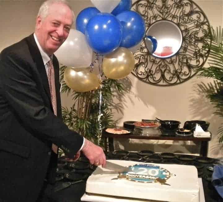 Kevin Toman, Englander president and CEO cuts a festive anniversary cake in celebration of the 120-year-old company.