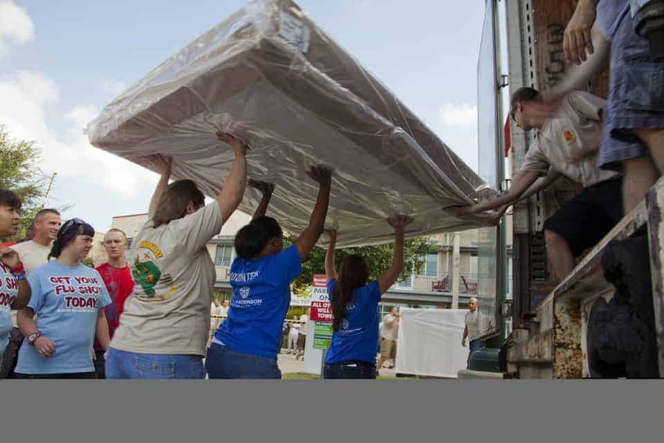 volunteers deliver tempurpedic beds at Ronald McDonald House