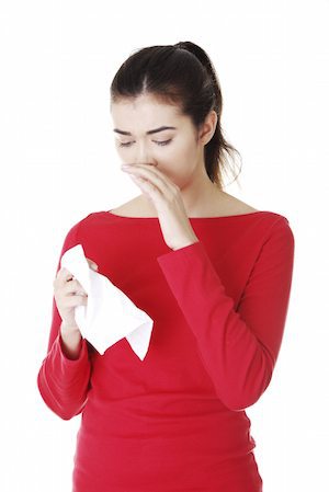 woman sneezing or about to blow her nose